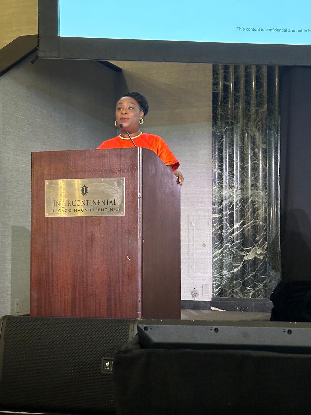 Dr Itunu Johnson speaking at a professional event in Chicago